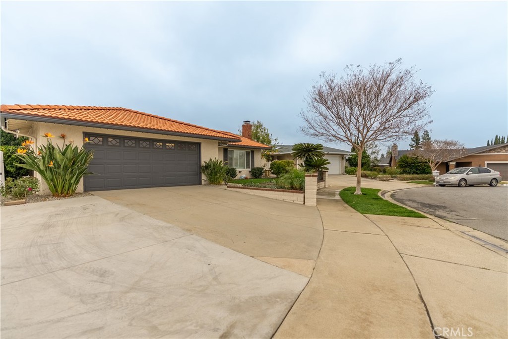 10328 Ivy Court Rancho Cucamonga, CA 91730 - Photo 4 of 40 a front view of a building with a yard and a garage