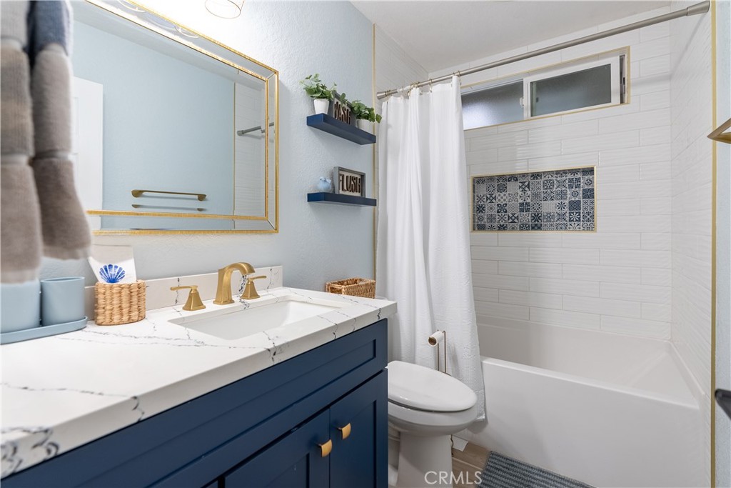 10328 Ivy Court Rancho Cucamonga, CA 91730 - Photo 6 of 40 a bathroom with a sink a toilet and shower