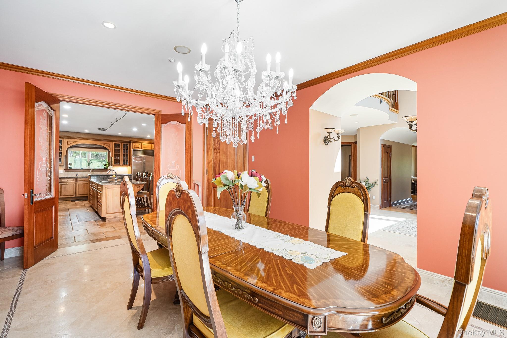 33 Winding Rd Farm Ardsley, NY 10502 - Photo 14 of 50 Dining area featuring arched walkways, recessed lighting, ornamental molding, and a chandelier