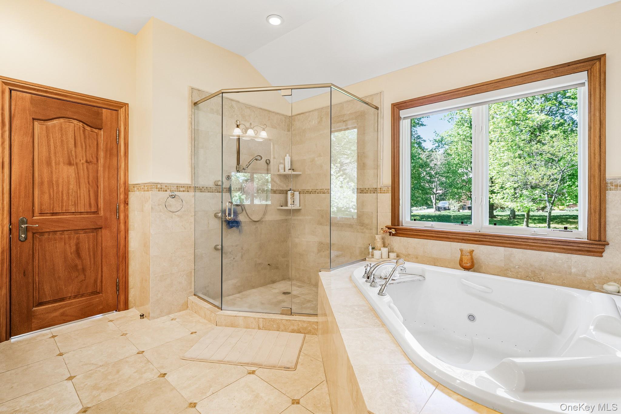 33 Winding Rd Farm Ardsley, NY 10502 - Photo 19 of 50 Full bath featuring a jetted tub, a shower stall, tile patterned floors, and lofted ceiling