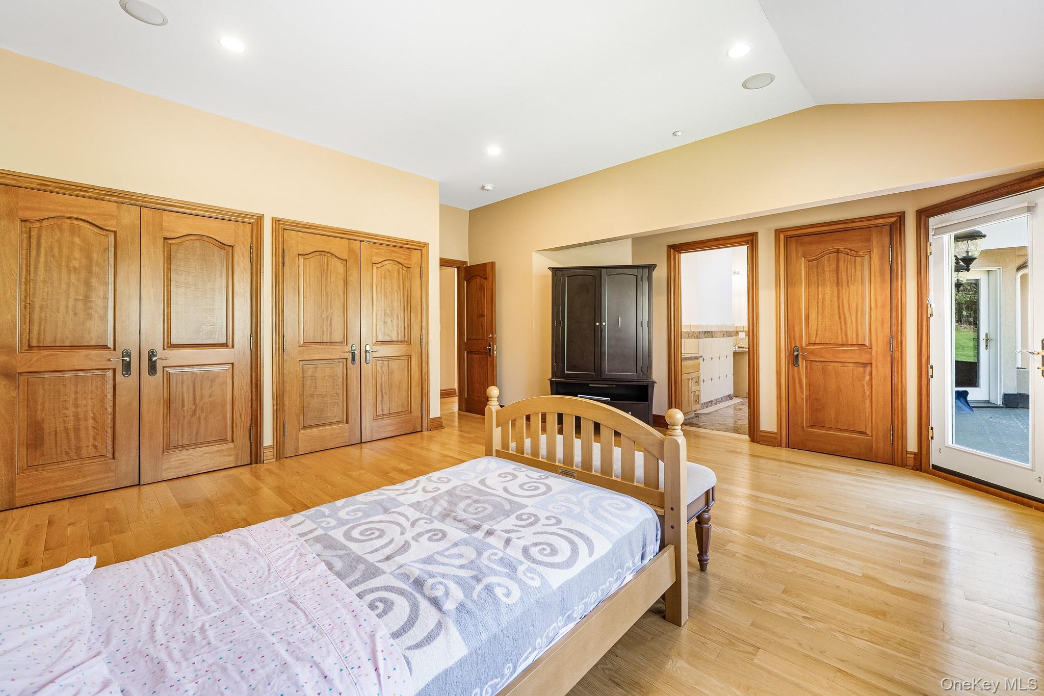 33 Winding Rd Farm Ardsley, NY 10502 - Photo 25 of 50 Bedroom with light wood-style floors, multiple closets, lofted ceiling, recessed lighting, and connected bathroom