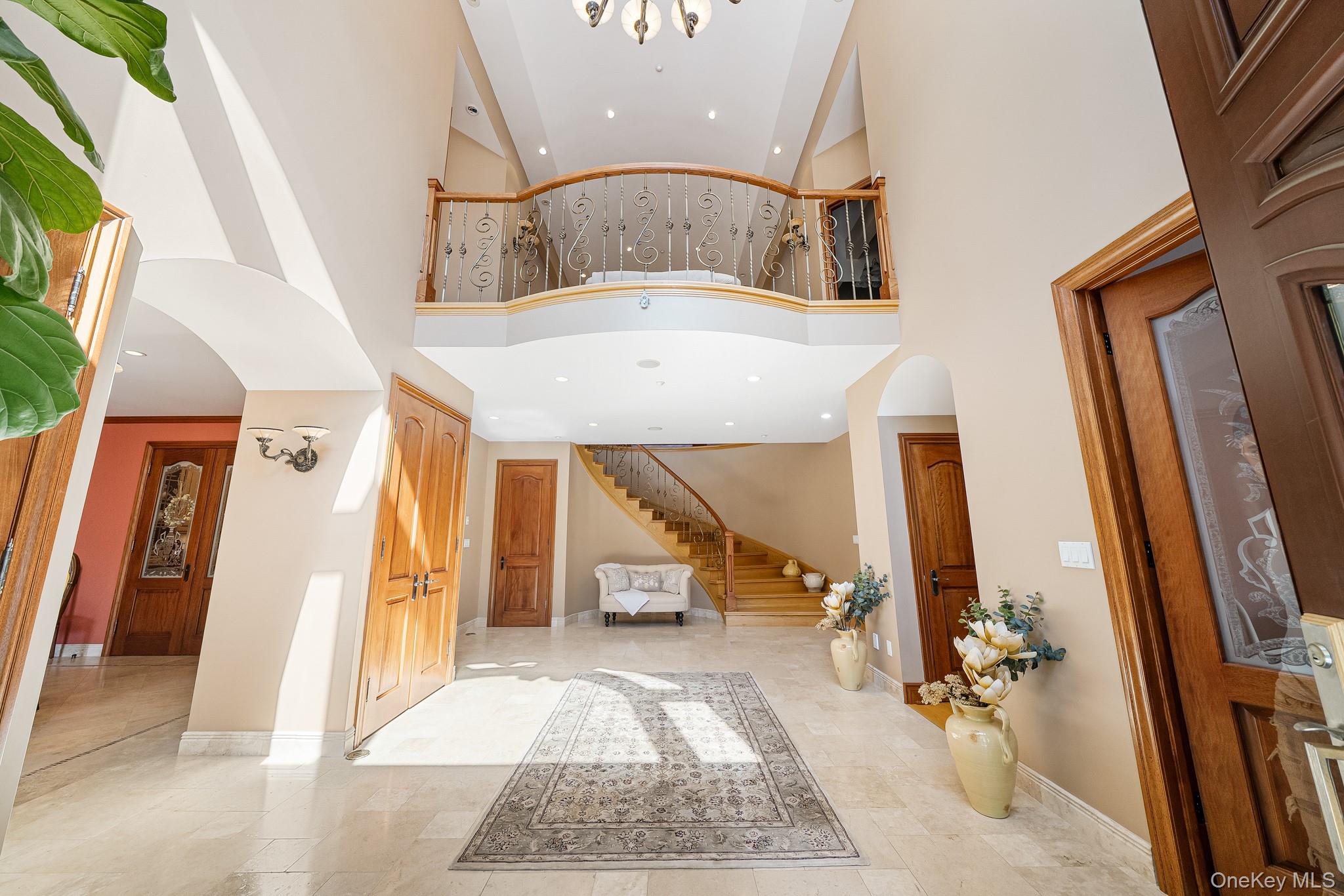 33 Winding Rd Farm Ardsley, NY 10502 - Photo 3 of 50 Entrance foyer with arched walkways, high vaulted ceiling, stairs, and recessed lighting