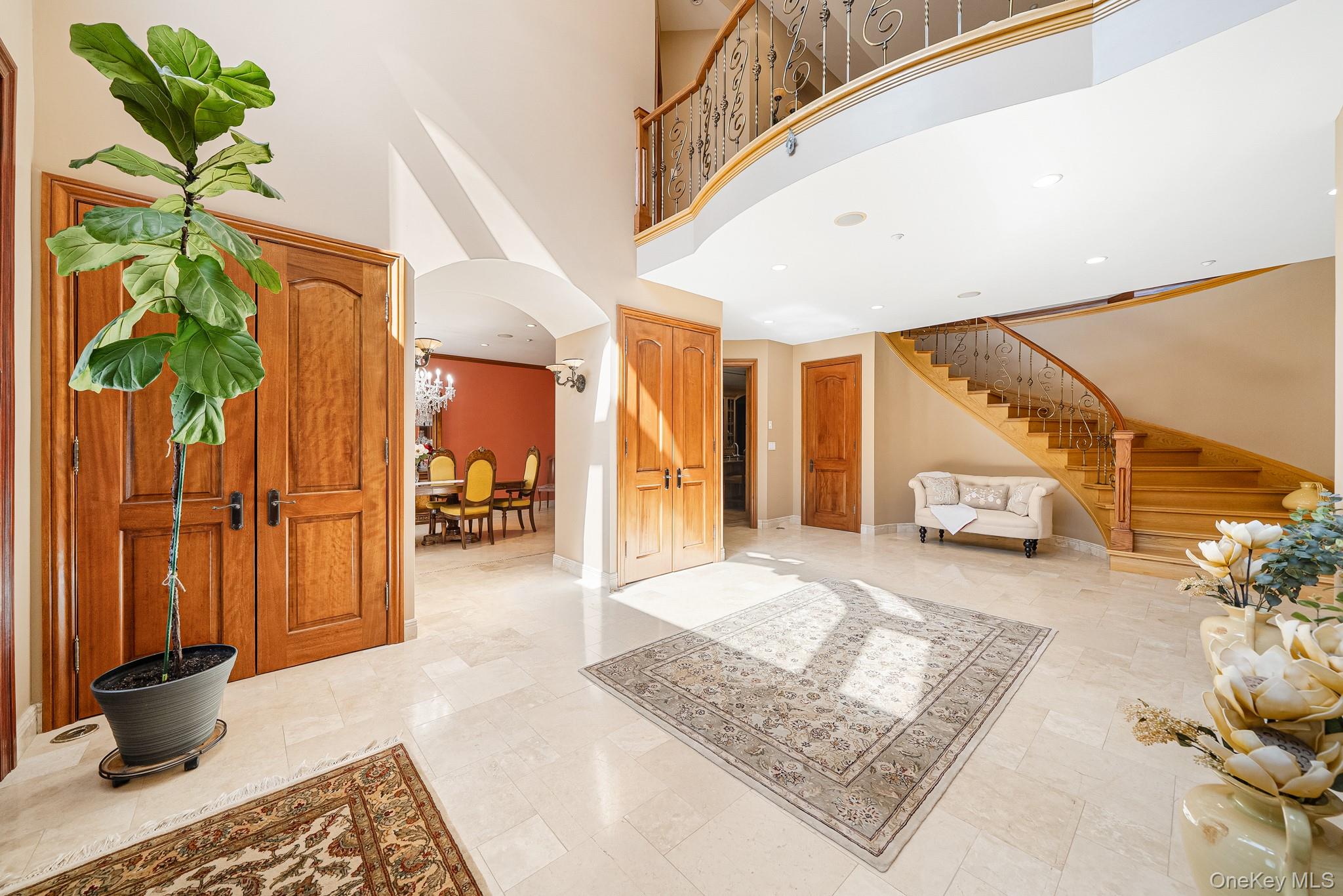 33 Winding Rd Farm Ardsley, NY 10502 - Photo 4 of 50 Entryway featuring stairs, arched walkways, and a towering ceiling