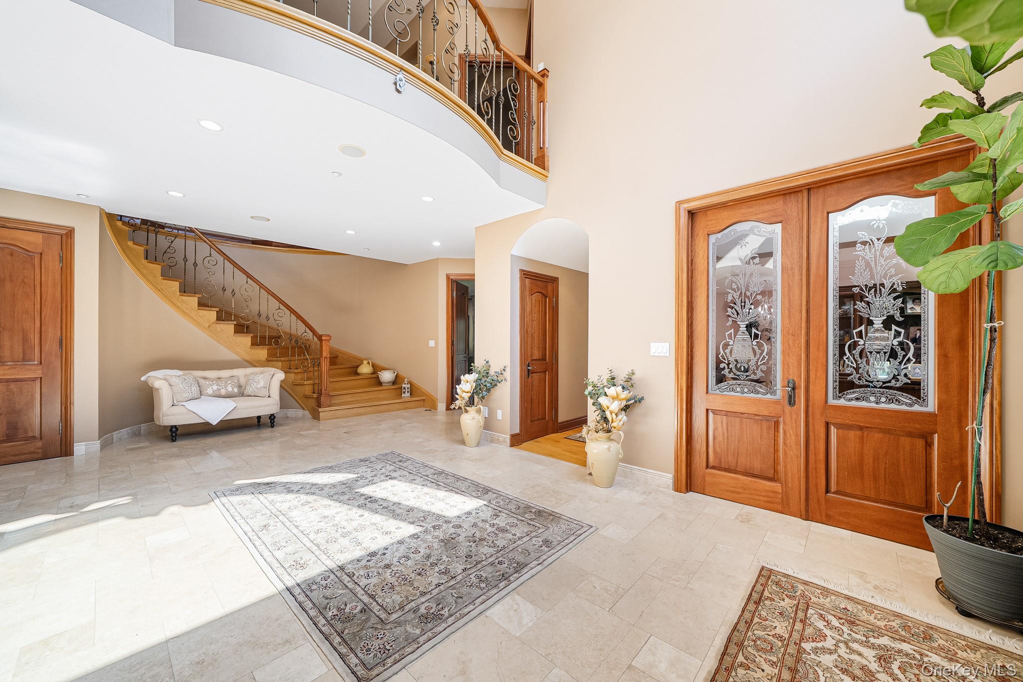 33 Winding Rd Farm Ardsley, NY 10502 - Photo 5 of 50 Foyer entrance featuring stairs, french doors, arched walkways, a towering ceiling, and recessed lighting