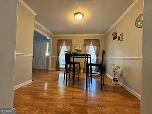 a view of a dining room with furniture and wooden floor