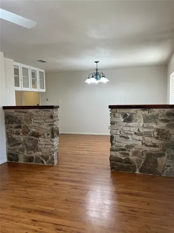 a view of water heater room with wooden floor