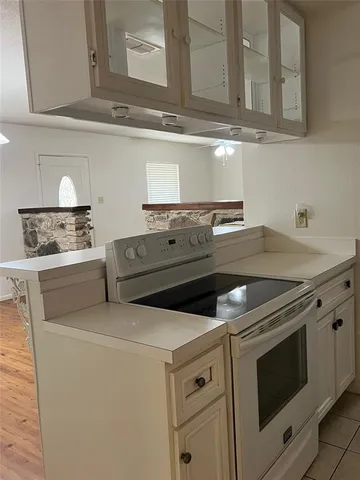 a stove top oven sitting inside of a kitchen