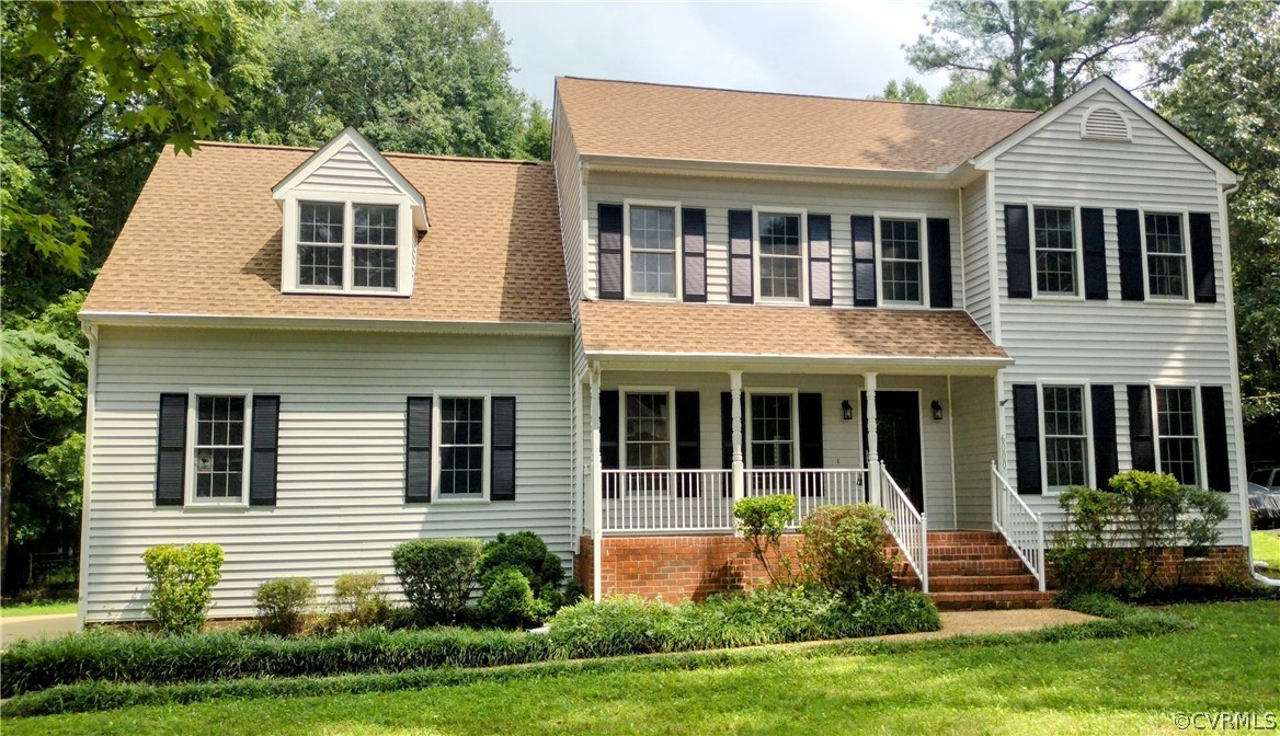 a front view of a house with garden and porch