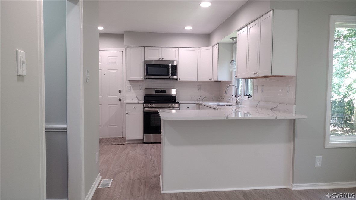 6000 Middlefield Place Chesterfield, VA 23832 - Photo 8 of 32 a kitchen with stainless steel appliances granite countertop a stove a sink and a refrigerator