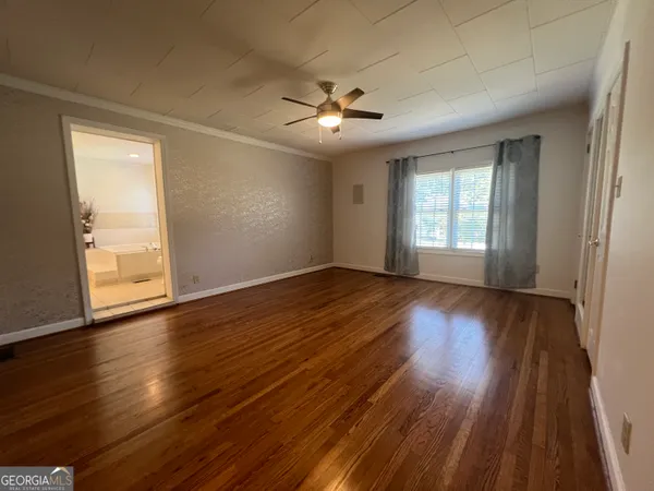 a view of a hallway with wooden floor