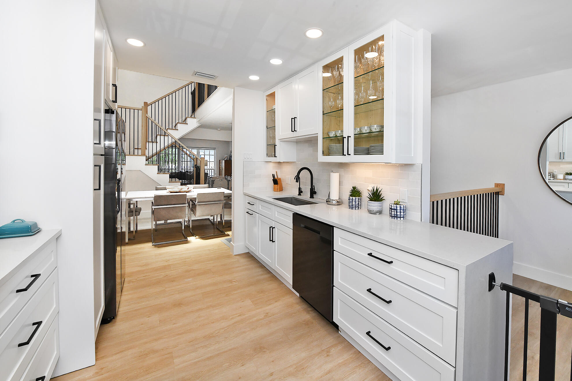 a kitchen with stainless steel appliances kitchen island granite countertop a sink cabinets and wooden floor