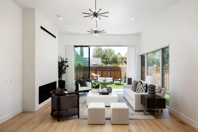 a living room with furniture and a chandelier