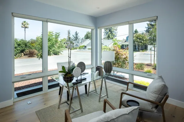 a dining room with furniture water view and wooden floor