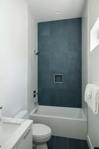 a bathroom with a toilet a sink and bathtub