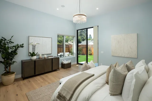 a bed room with a bed and a chandelier