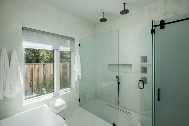 a bathroom with a shower and toilet