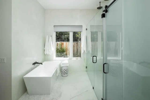 a bathroom with a bathtub and shower