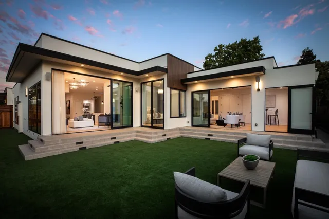 a view of a house with a big yard and patio