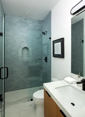 a bathroom with a toilet sink and shower