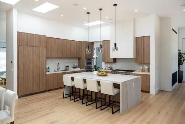 a kitchen with a dining table chairs refrigerator and cabinets