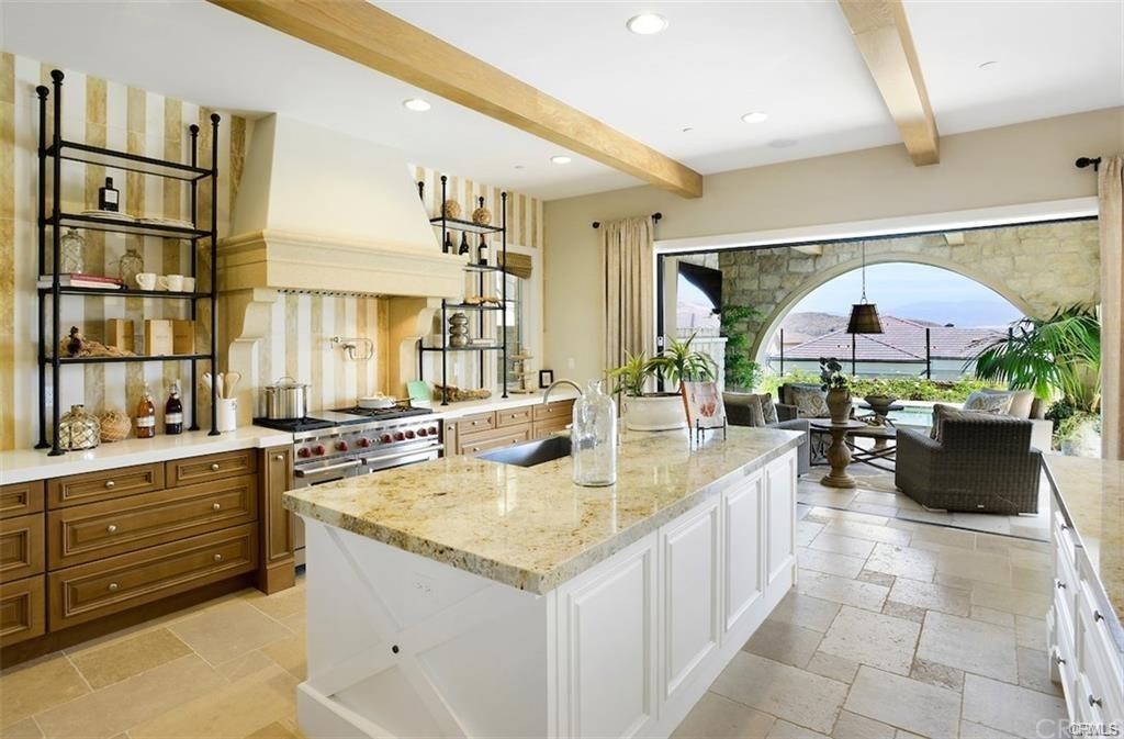 123 Amber Sky Irvine, CA 92618 - Photo 11 of 43 a kitchen with a stove a refrigerator and a stove