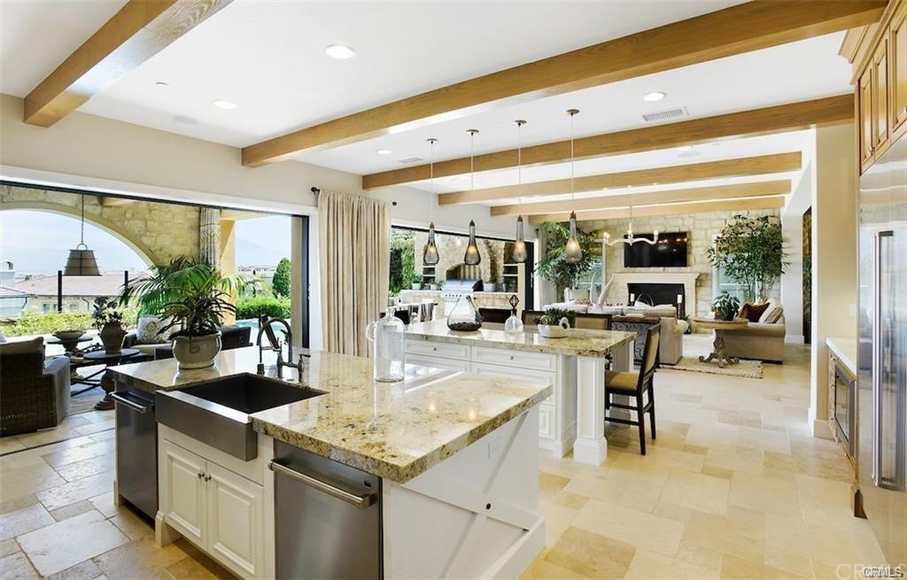 123 Amber Sky Irvine, CA 92618 - Photo 12 of 43 a kitchen with counter top space and living room