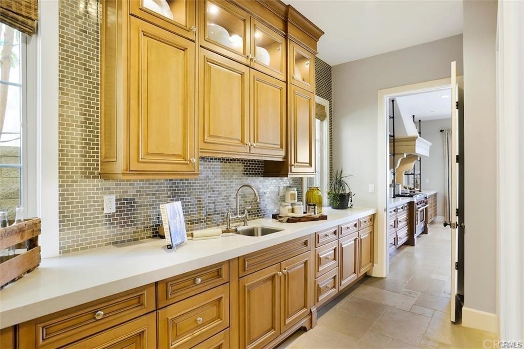 123 Amber Sky Irvine, CA 92618 - Photo 14 of 43 a kitchen with stainless steel appliances sink cabinets and window