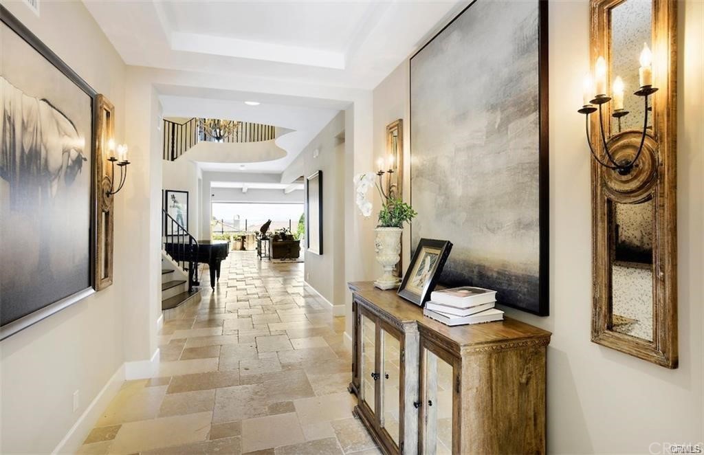 123 Amber Sky Irvine, CA 92618 - Photo 2 of 43 a view of a hallway with dining area and glass door