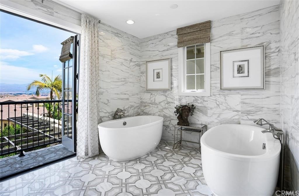 123 Amber Sky Irvine, CA 92618 - Photo 23 of 43 a bathroom with a bathtub and shower