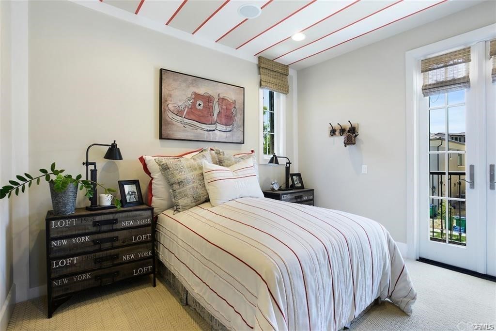 123 Amber Sky Irvine, CA 92618 - Photo 27 of 43 a bedroom with bed and wooden floor