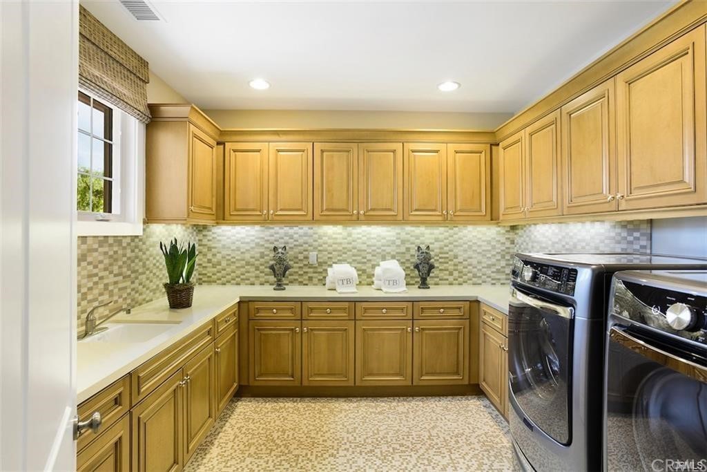 123 Amber Sky Irvine, CA 92618 - Photo 29 of 43 a kitchen with a sink stove and cabinets