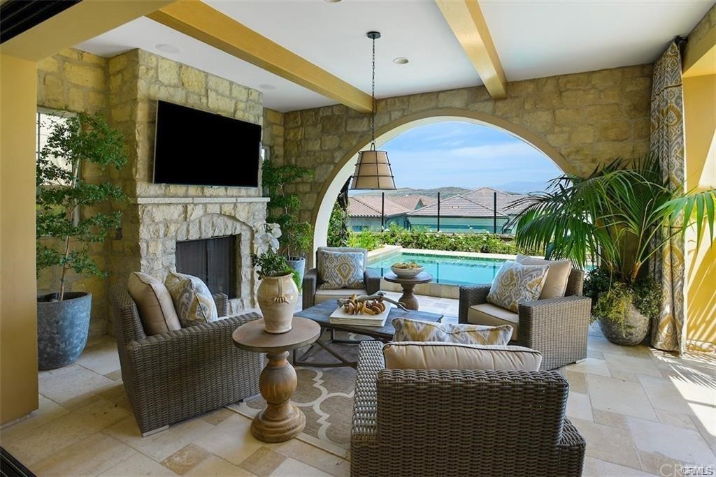 123 Amber Sky Irvine, CA 92618 - Photo 34 of 43 a living room with fireplace furniture and a flat screen tv