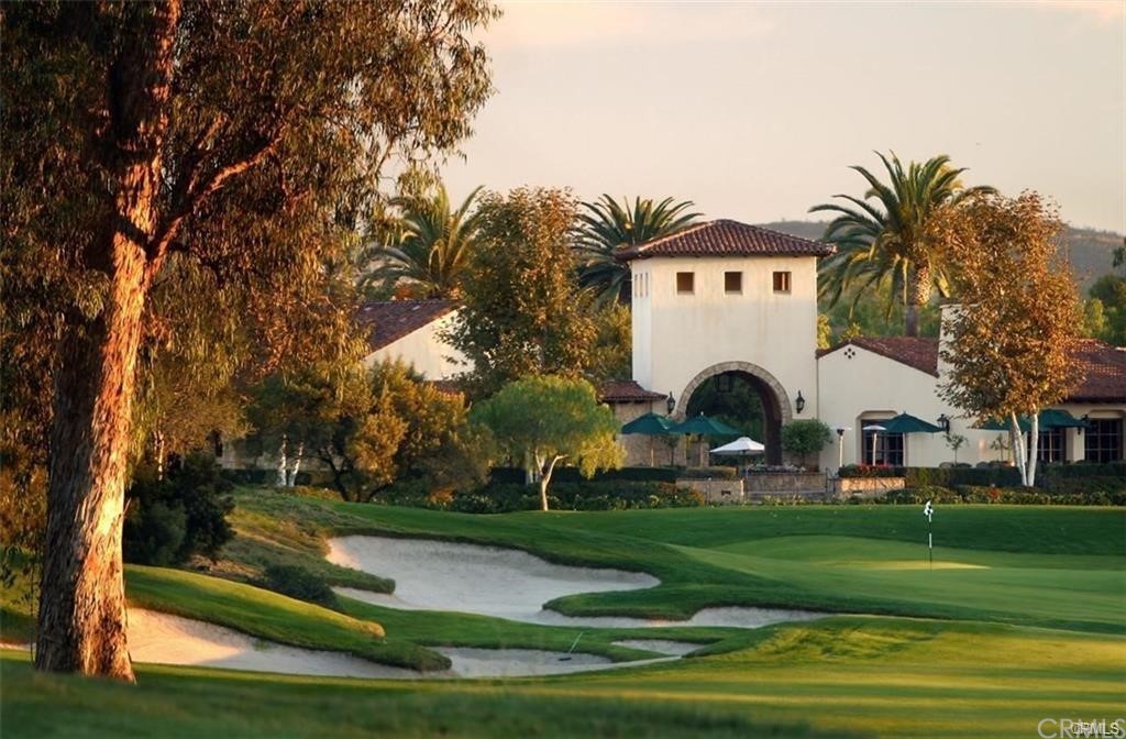 123 Amber Sky Irvine, CA 92618 - Photo 42 of 43 a view of a white house with a yard table and chairs
