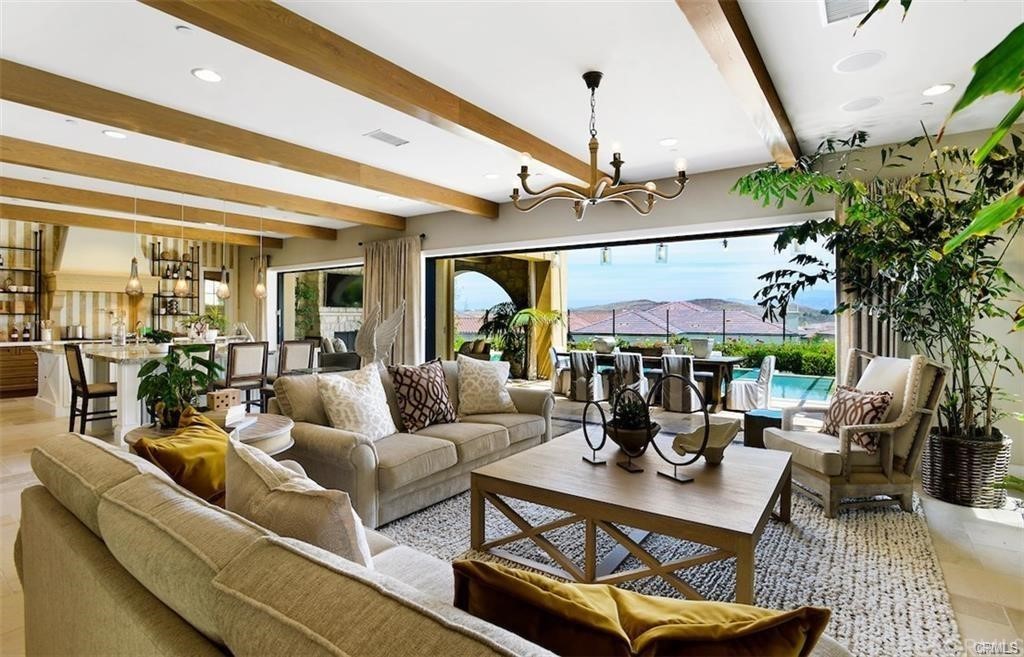 123 Amber Sky Irvine, CA 92618 - Photo 7 of 43 a living room with furniture a chandelier