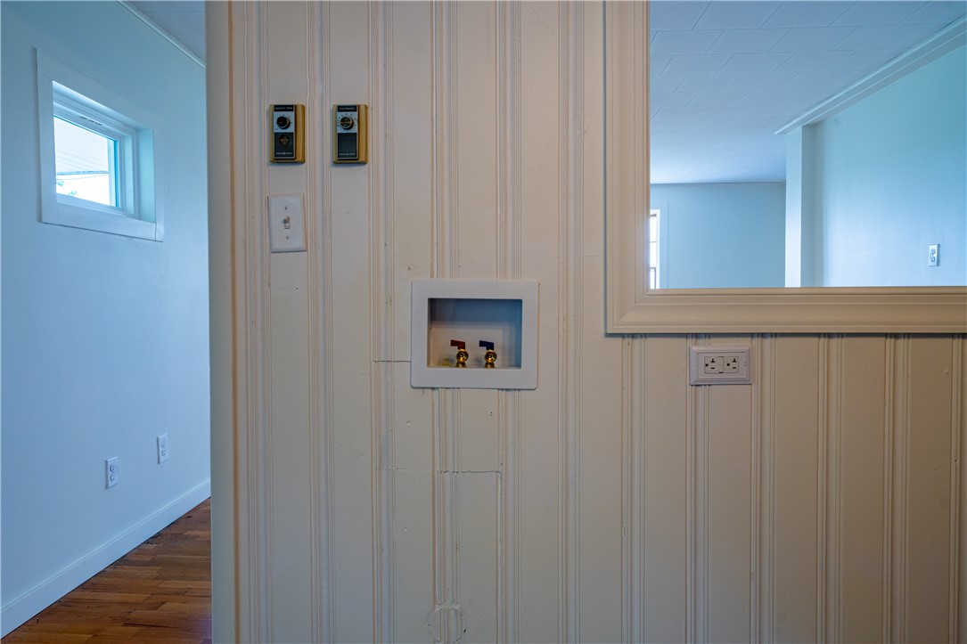 11296 Pansing Road Brookville, OH 45309 - Photo 16 of 53 This laundry area features beadboard walls and hardwood floors, ready for appliances.