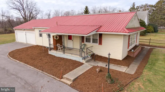 a front view of a house with table and chairs