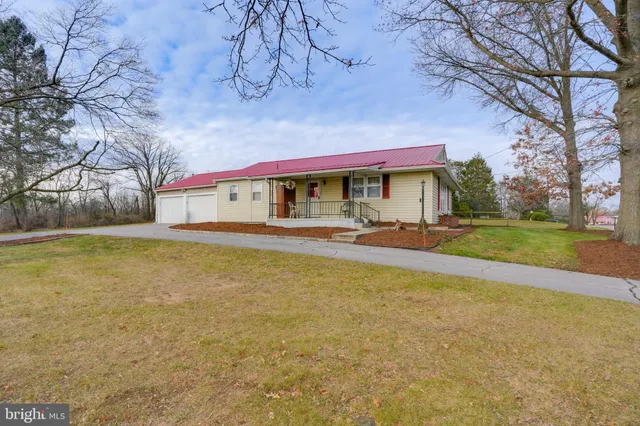 a front view of house with yard and swimming pool