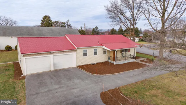 a view of a house with a yard and sitting area