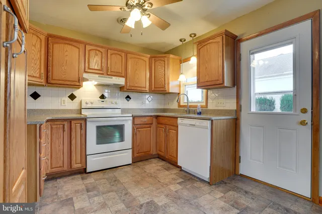 a kitchen with cabinets stainless steel appliances and window
