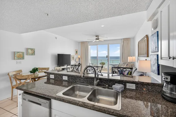 a kitchen with sink stove and cabinets