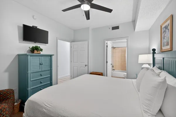a bedroom with a bed and a flat screen tv