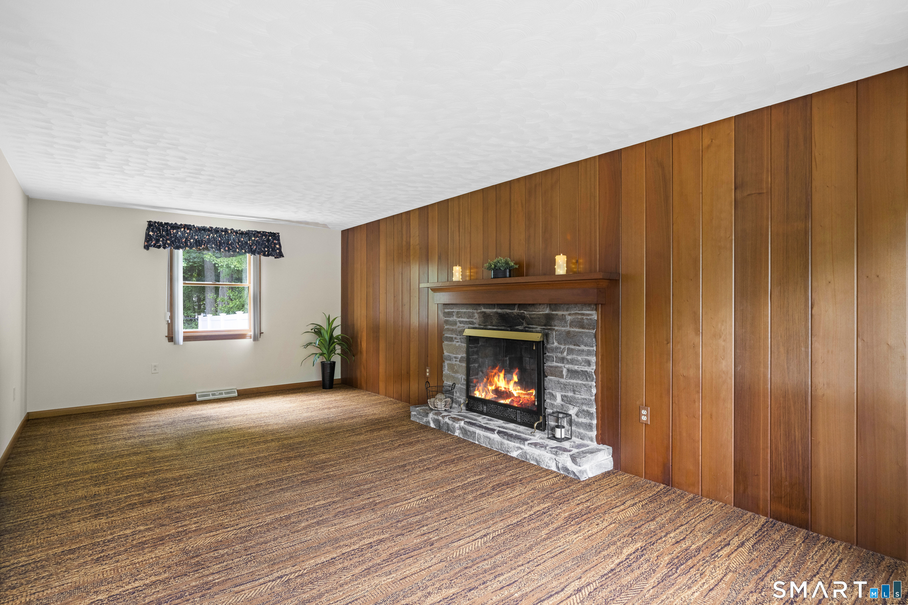6 Cartier Road Enfield, CT 06082 - Photo 20 of 40 a view of an empty room with wooden floor fireplace and a window