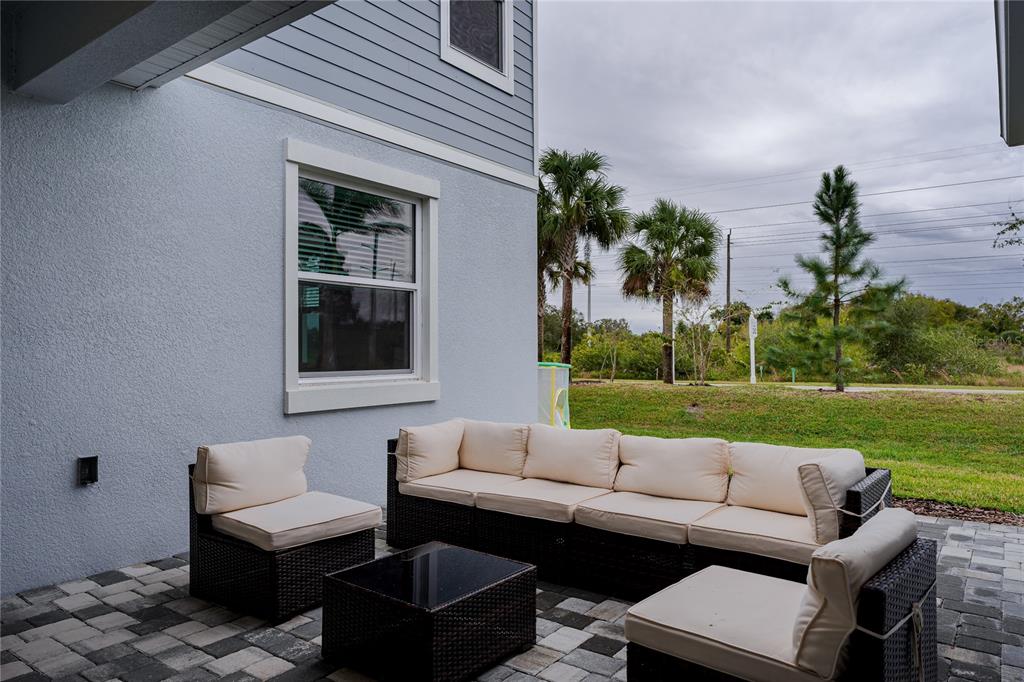 1912 Swivel Lane Sarasota, FL 34240 - Photo 11 of 48 a view of a patio with couches and a table and chairs with garden view