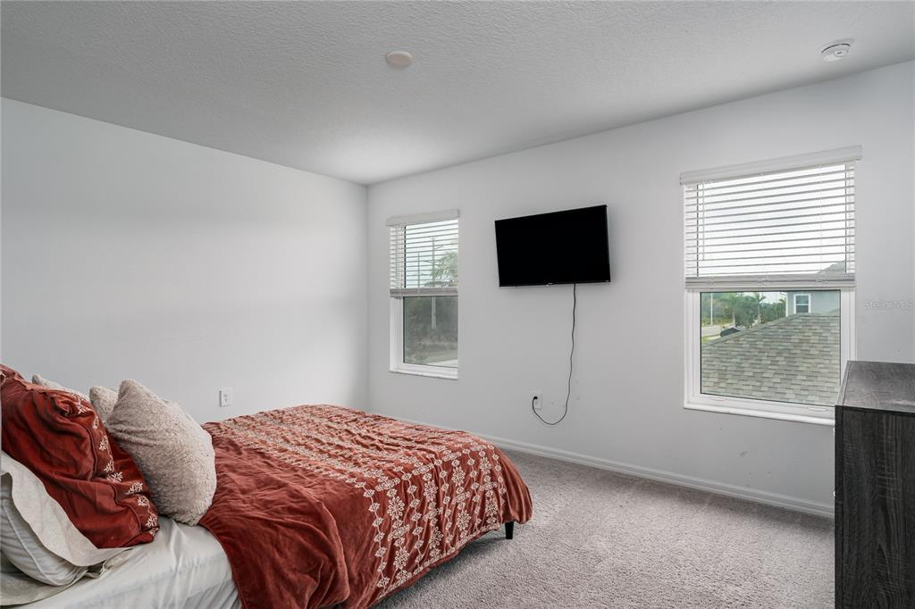 1912 Swivel Lane Sarasota, FL 34240 - Photo 16 of 48 a bedroom with a bed and a flat screen tv