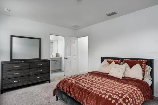 a bedroom with a bed and a television