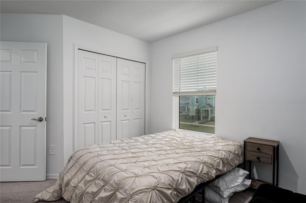 1912 Swivel Lane Sarasota, FL 34240 - Photo 23 of 48 a bedroom with a bed and a chair