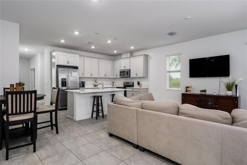 1912 Swivel Lane Sarasota, FL 34240 - Photo 3 of 48 a living room with furniture and a flat screen tv