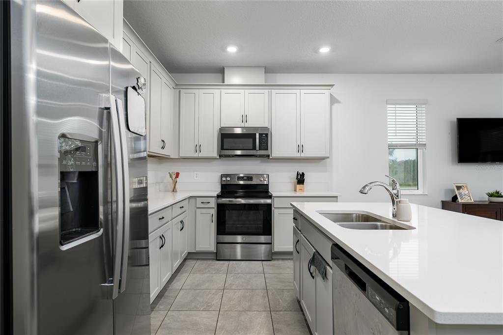 1912 Swivel Lane Sarasota, FL 34240 - Photo 4 of 48 a kitchen with granite countertop a sink stainless steel appliances and cabinets