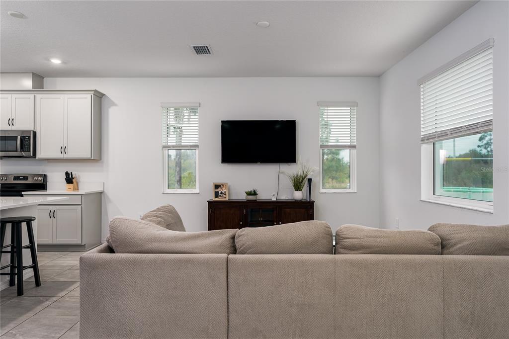 1912 Swivel Lane Sarasota, FL 34240 - Photo 5 of 48 a living room with furniture and a flat screen tv