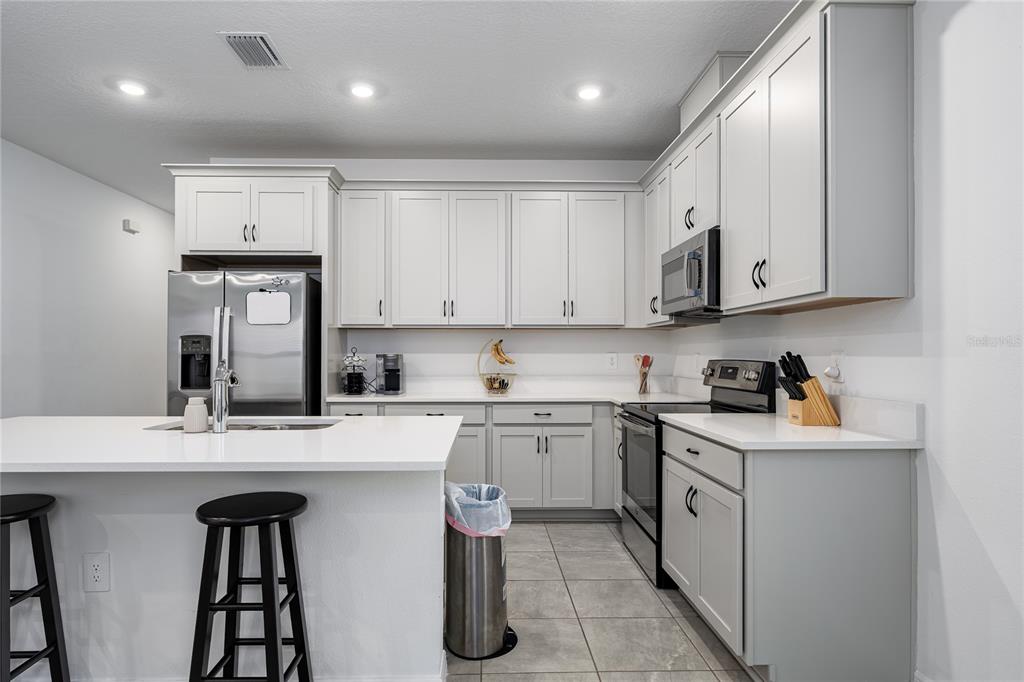 1912 Swivel Lane Sarasota, FL 34240 - Photo 6 of 48 a kitchen with stainless steel appliances granite countertop a sink and cabinets